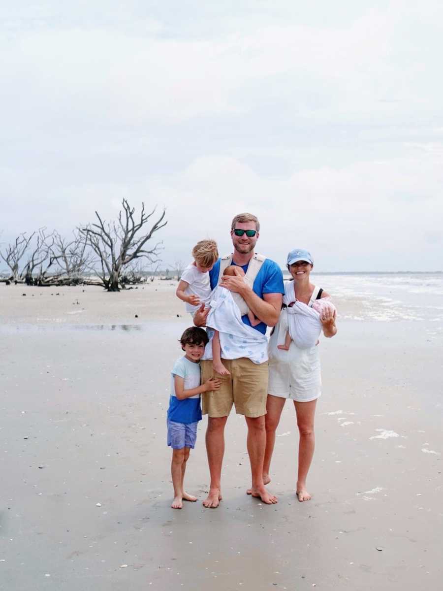 Family of six smiling at the beach