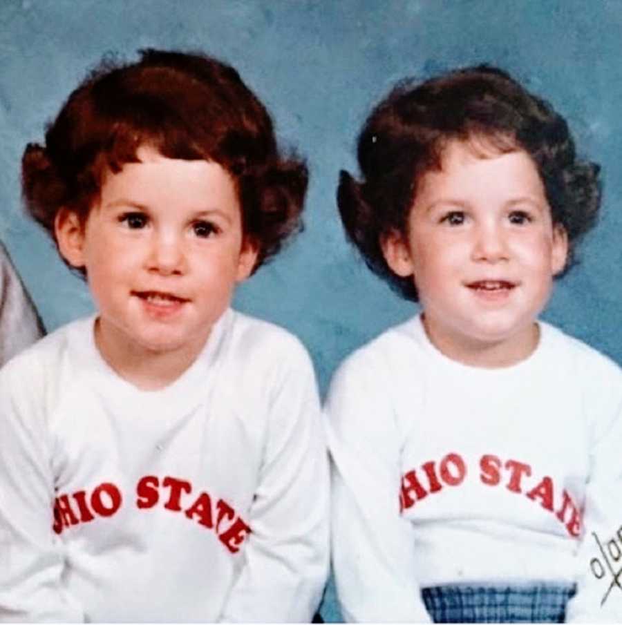 Twin girls with brown hair wearing white Ohio State shirts