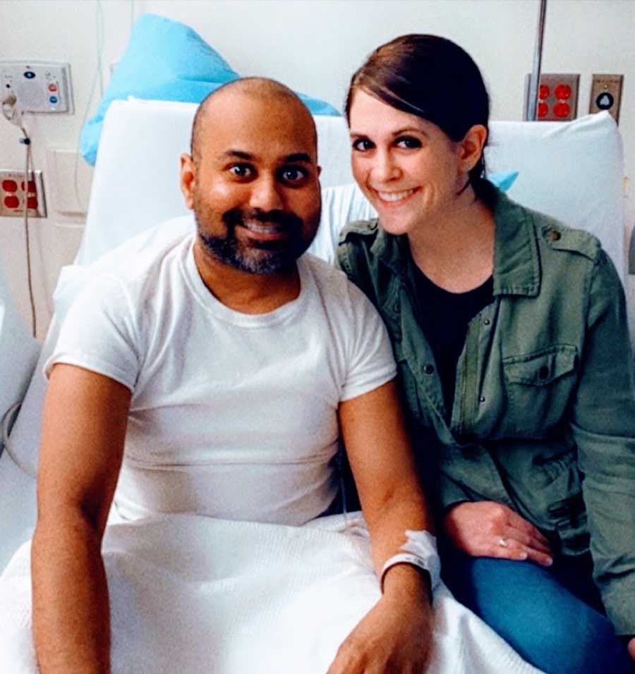 Man in hospital bed with woman smiling