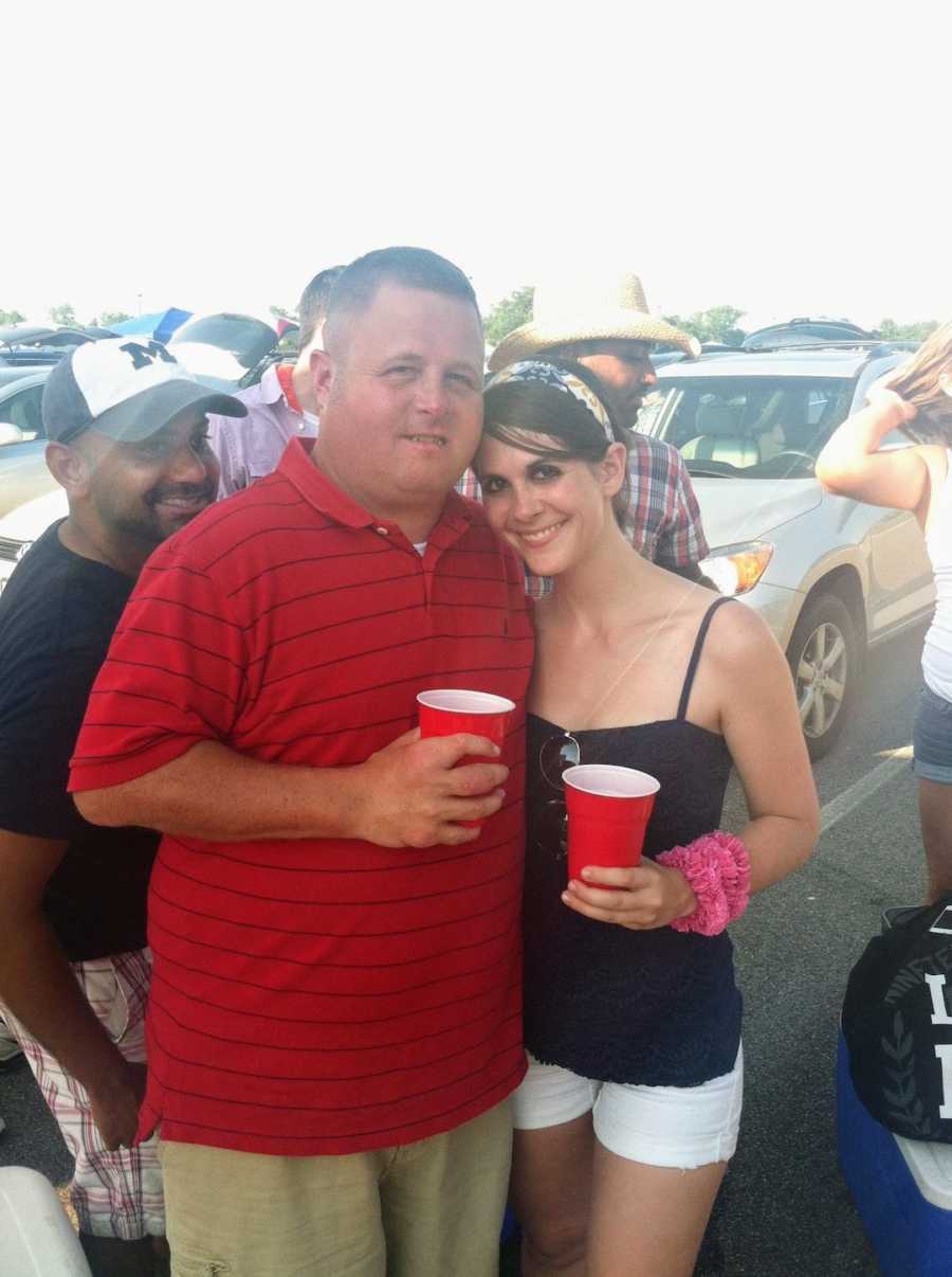 Woman and man taking picture at concert holding cups