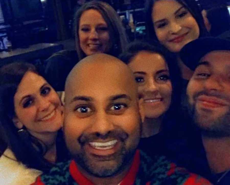 Group of people taking smiling selfie