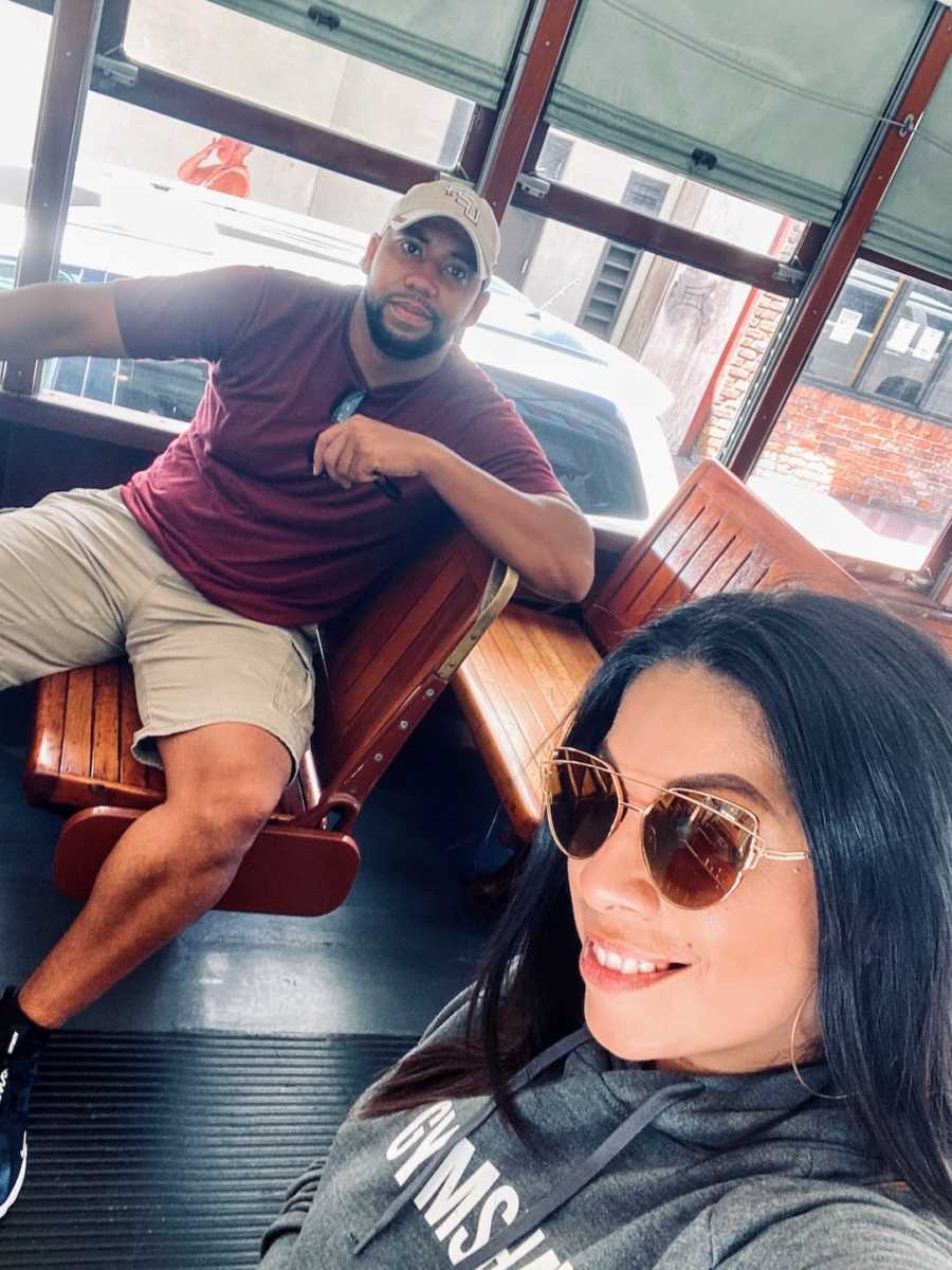 Couple sitting on bus taking selfie