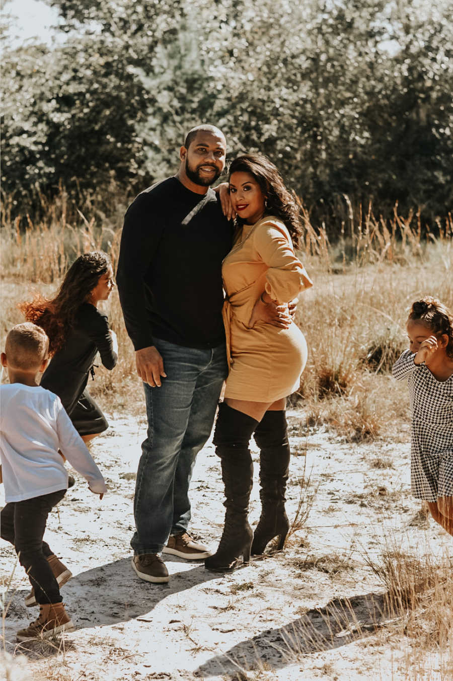 Family of five standing outside laughing