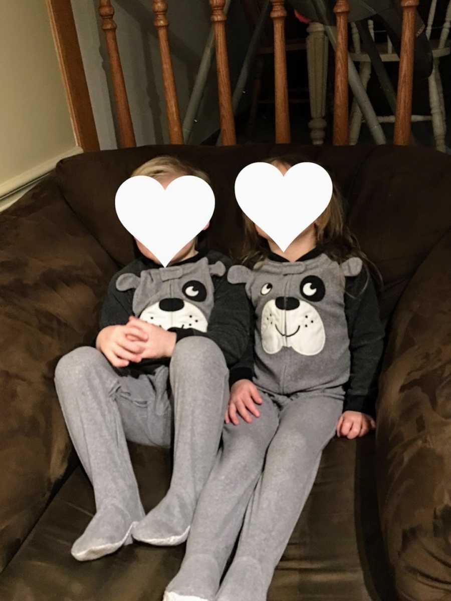 Foster siblings sitting on couch wearing matching pajamas