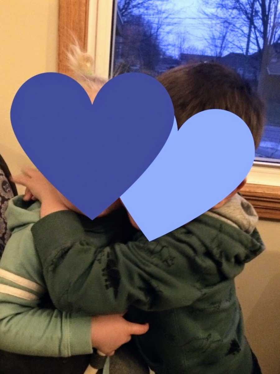 Foster brothers wearing green hugging each other