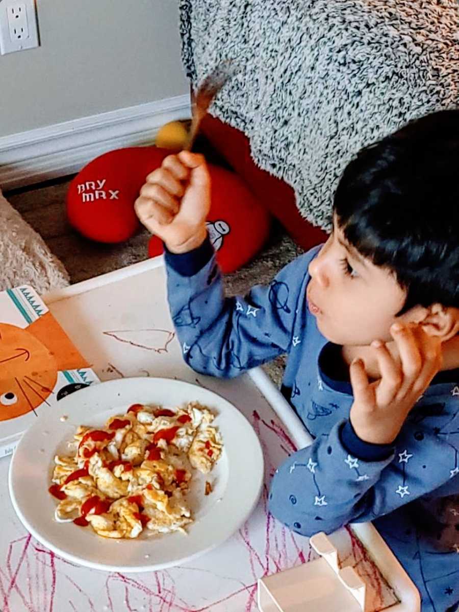 A young boy with autism eating a meal 