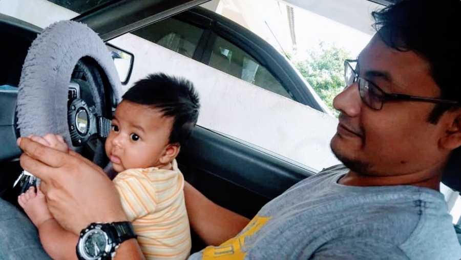 A father with his young son in a car