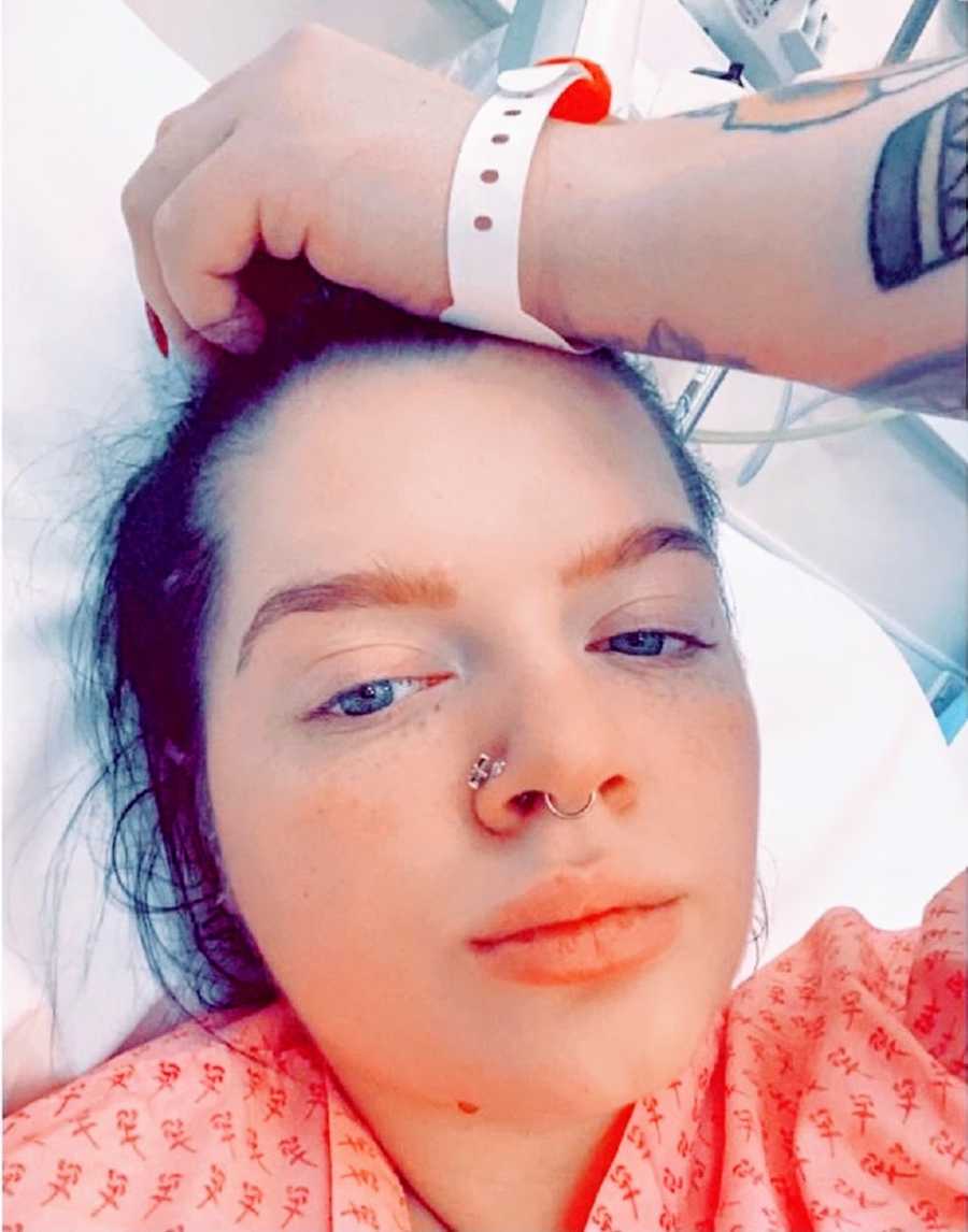 A woman with chronic illness lies in a hospital bed