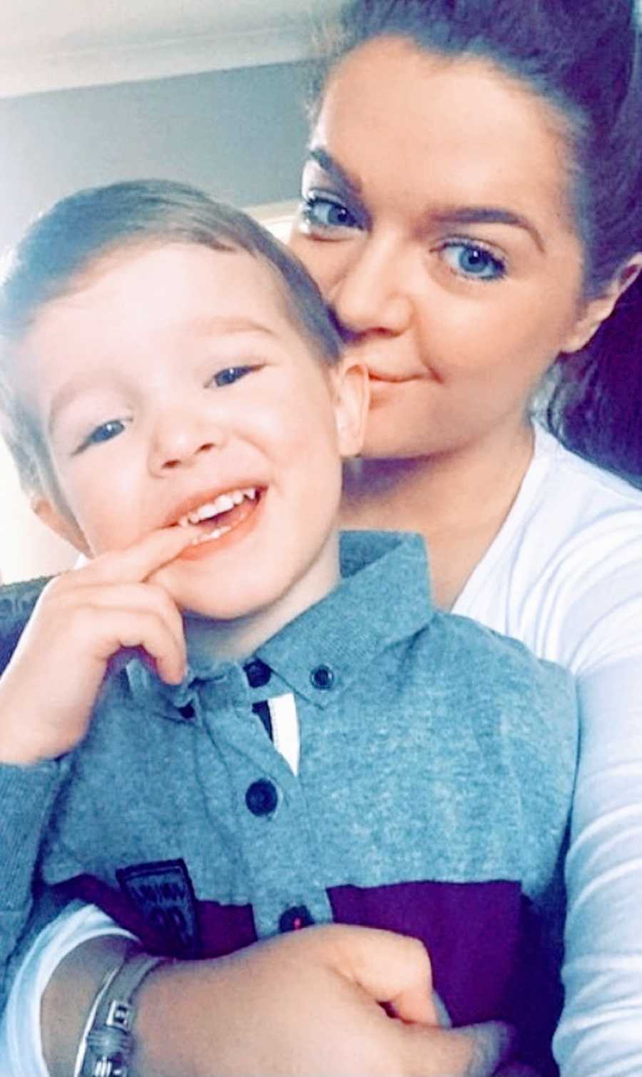 A woman with chronic illness holds her son