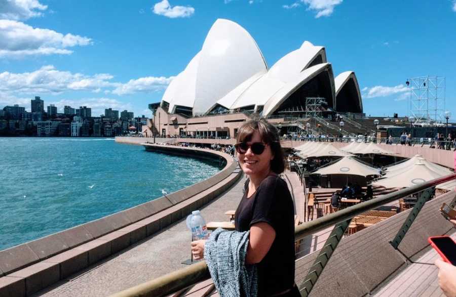 Woman standing in front of Sydney Opera House