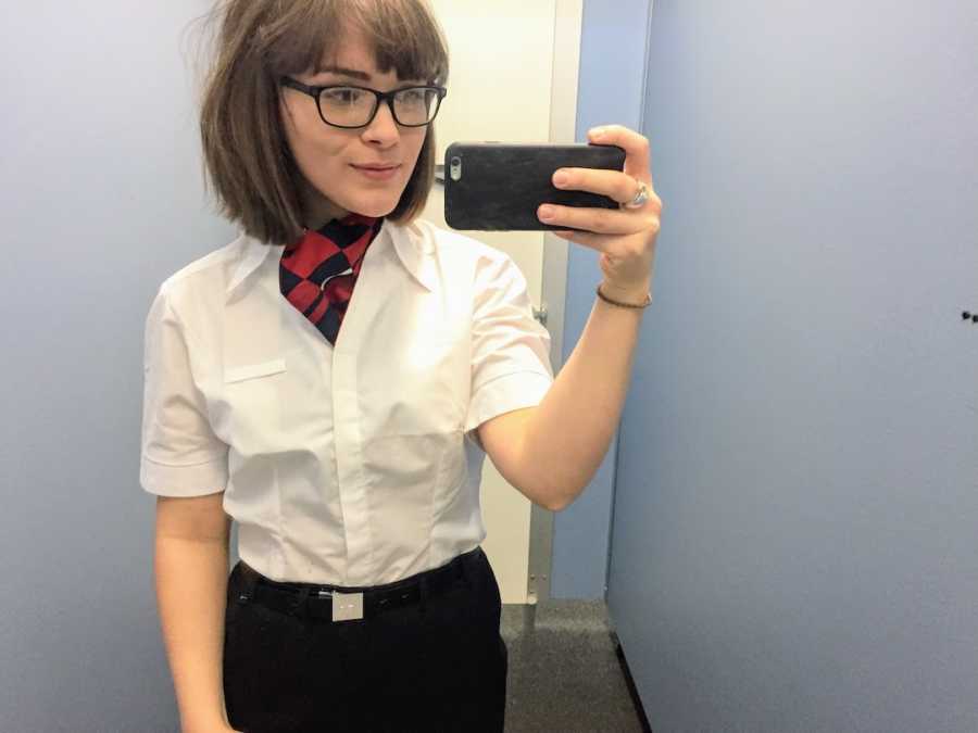 Woman flight attendant taking selfie in mirror