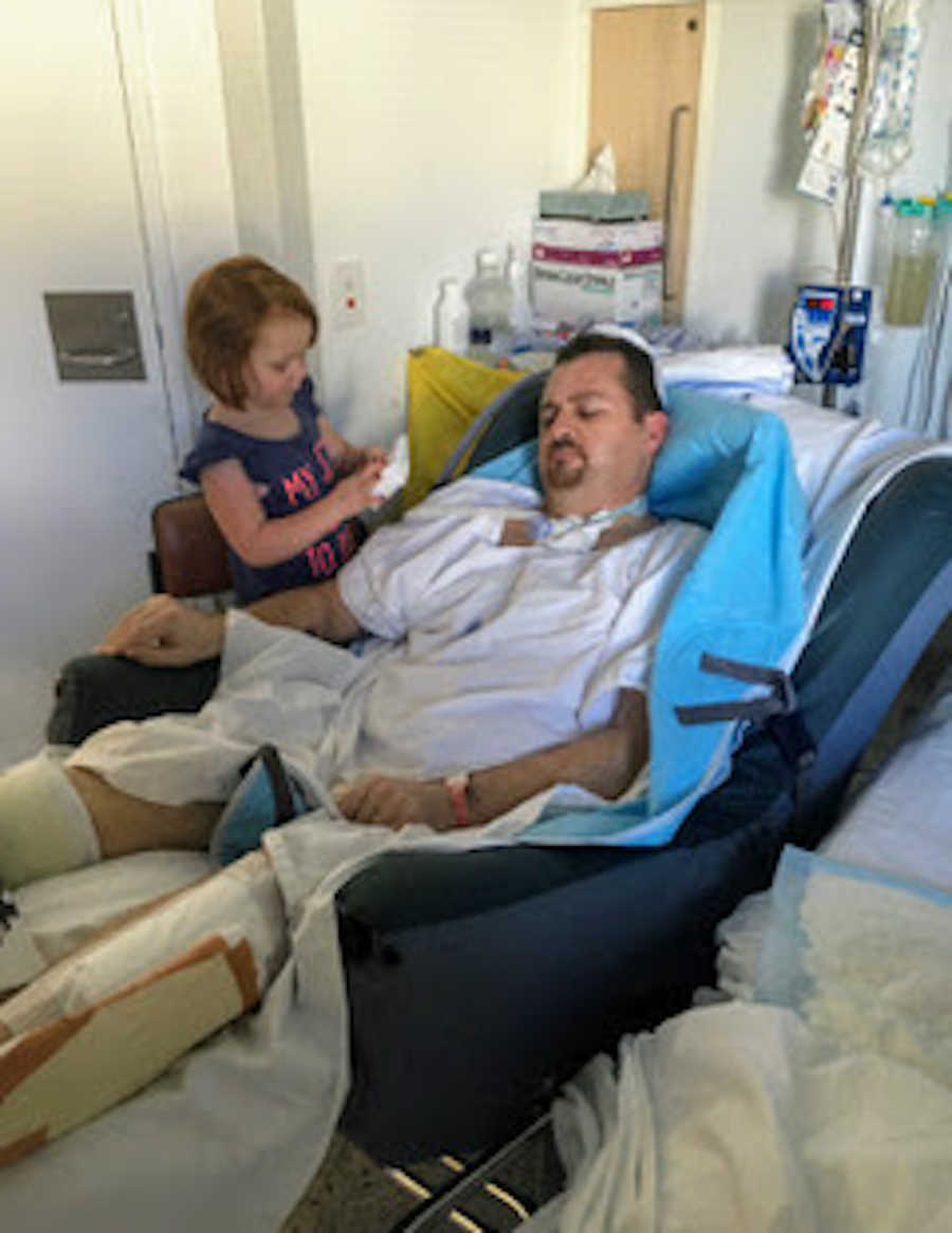 Father in hospital bed and daughter talking to him