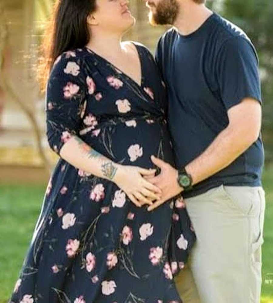 maternity photo of couple embracing