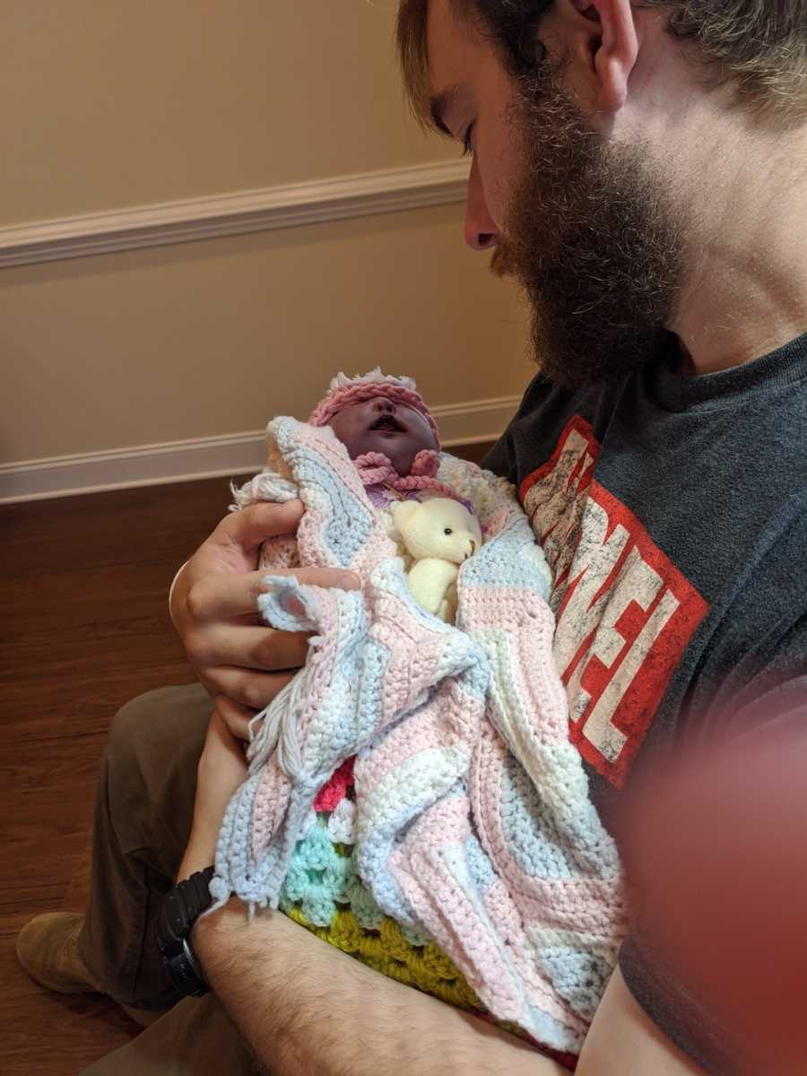 dad holding his newborn baby