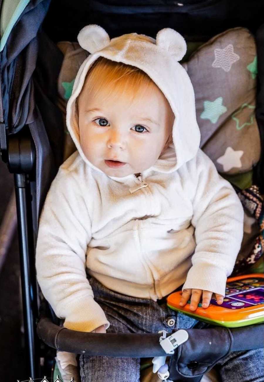 First time mom takes photo of her son in his stroller with a fuzzy jacket on