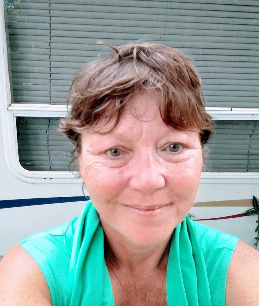 Woman living in Florida takes a selfie outside of her RV camper