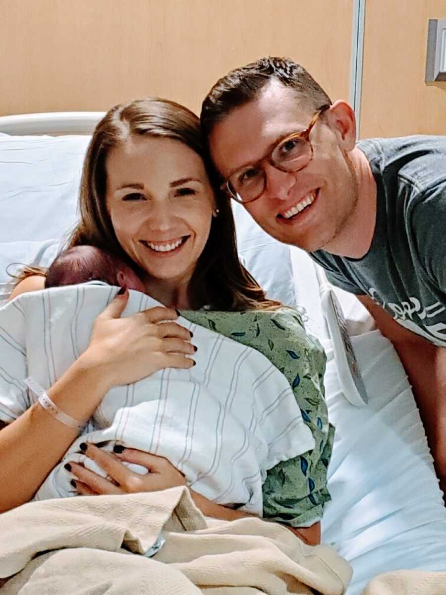Adoptive parents take photo with their newborn adopted son in the hospital