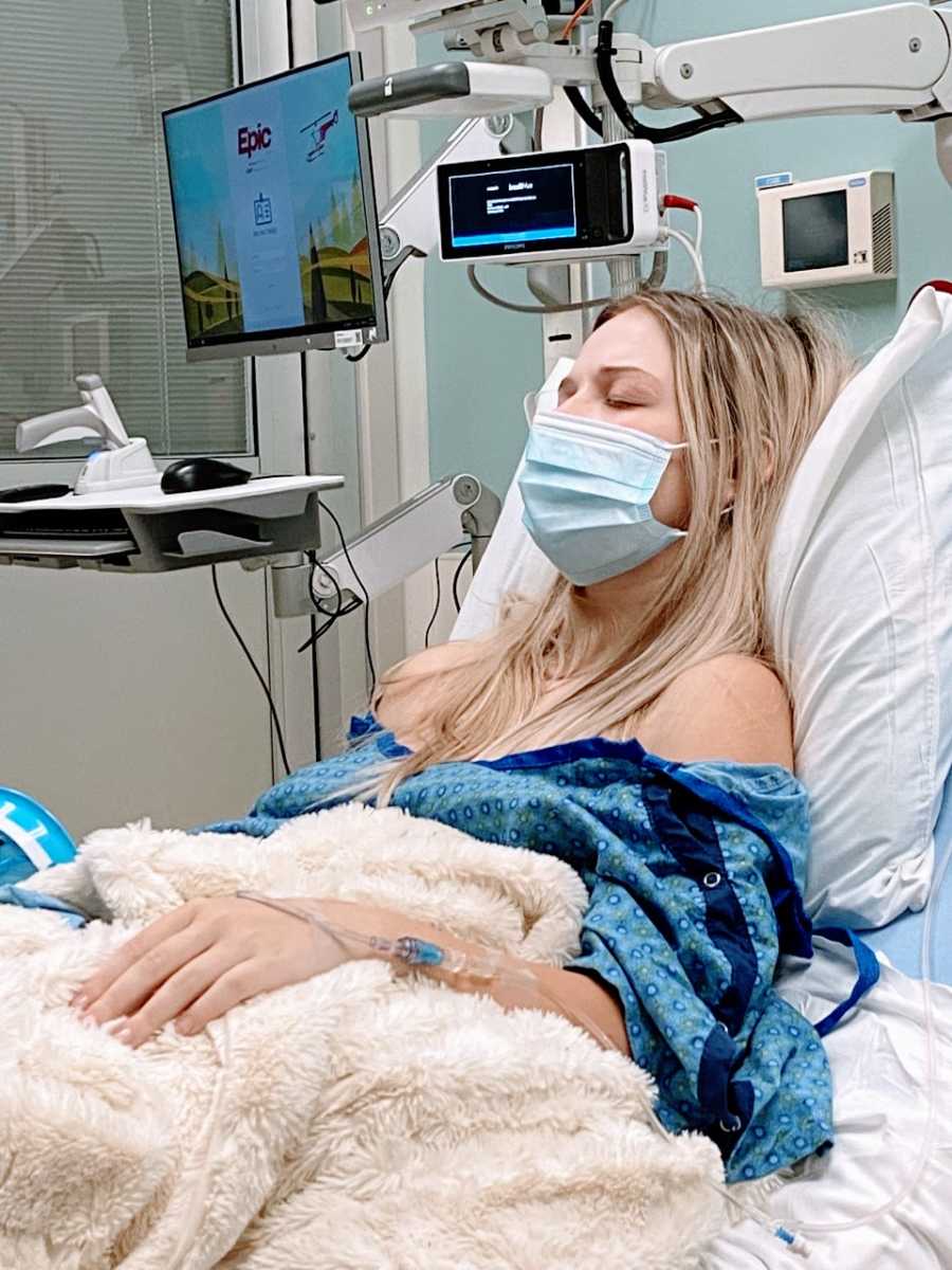 Pregnant woman battling Hyperemesis Gravidarum rests during one of her many hospital stays