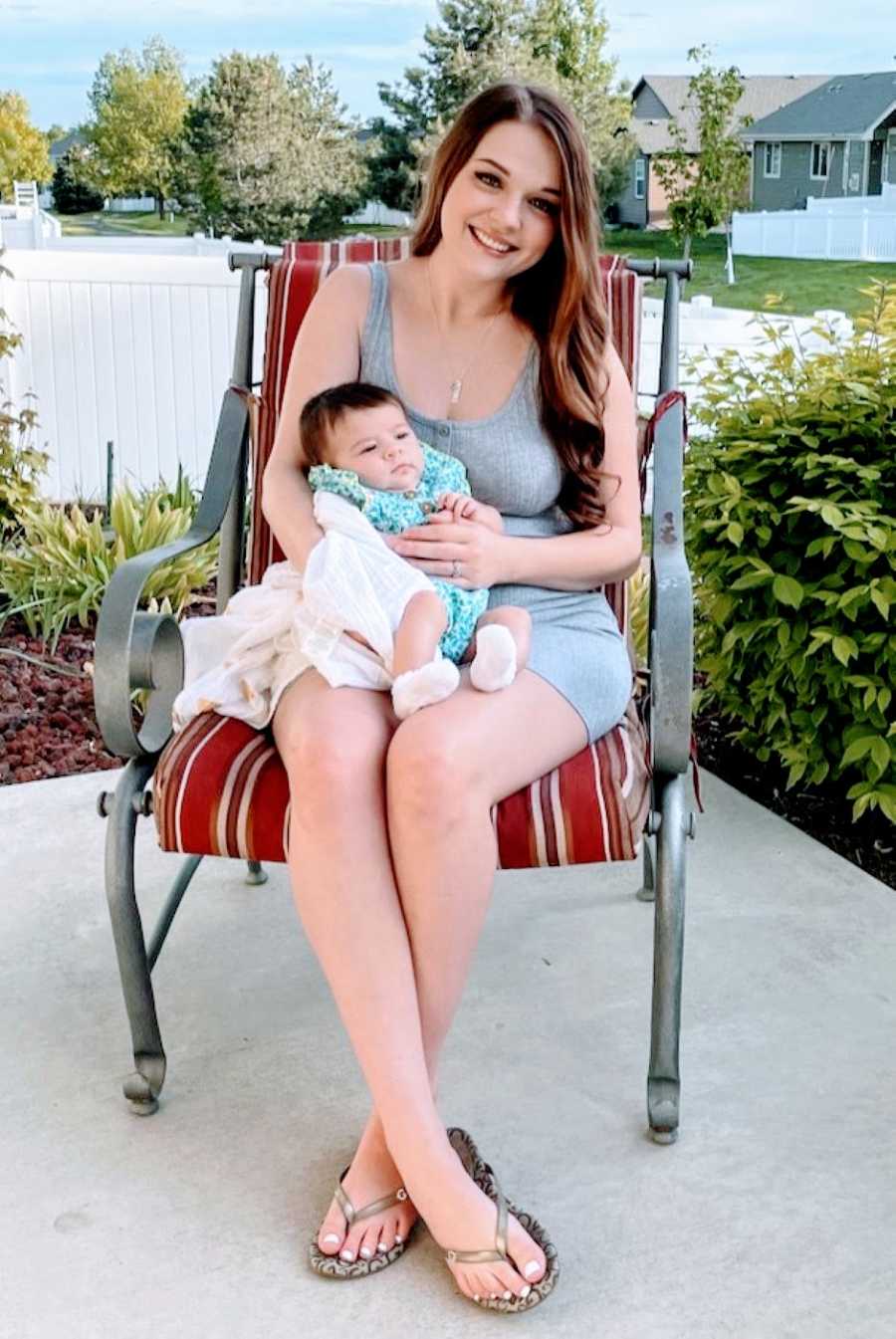 Stay at home mom sits with newborn daughter on her front porch after winning her battle with rare HG