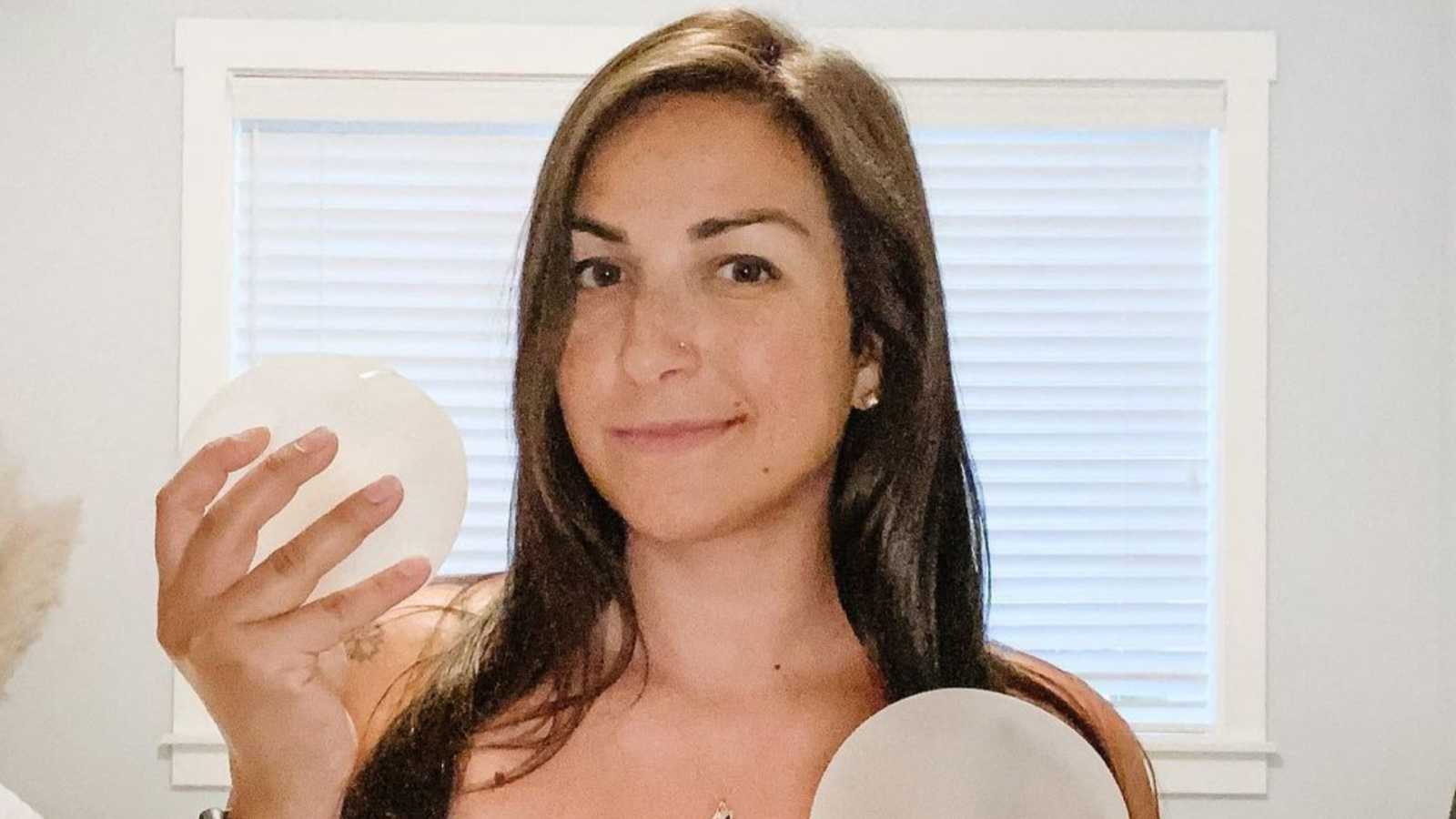 woman holding breast implant
