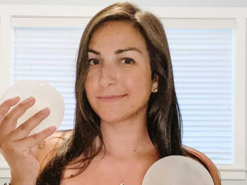 woman holding breast implant