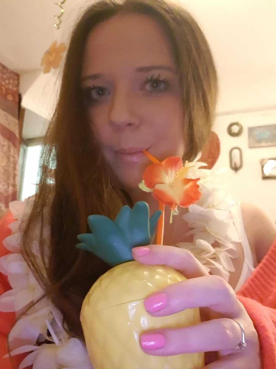 woman holding flowery drink