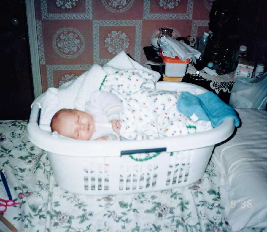 Mom snaps photo of newborn son taking a nap in a laundry basket