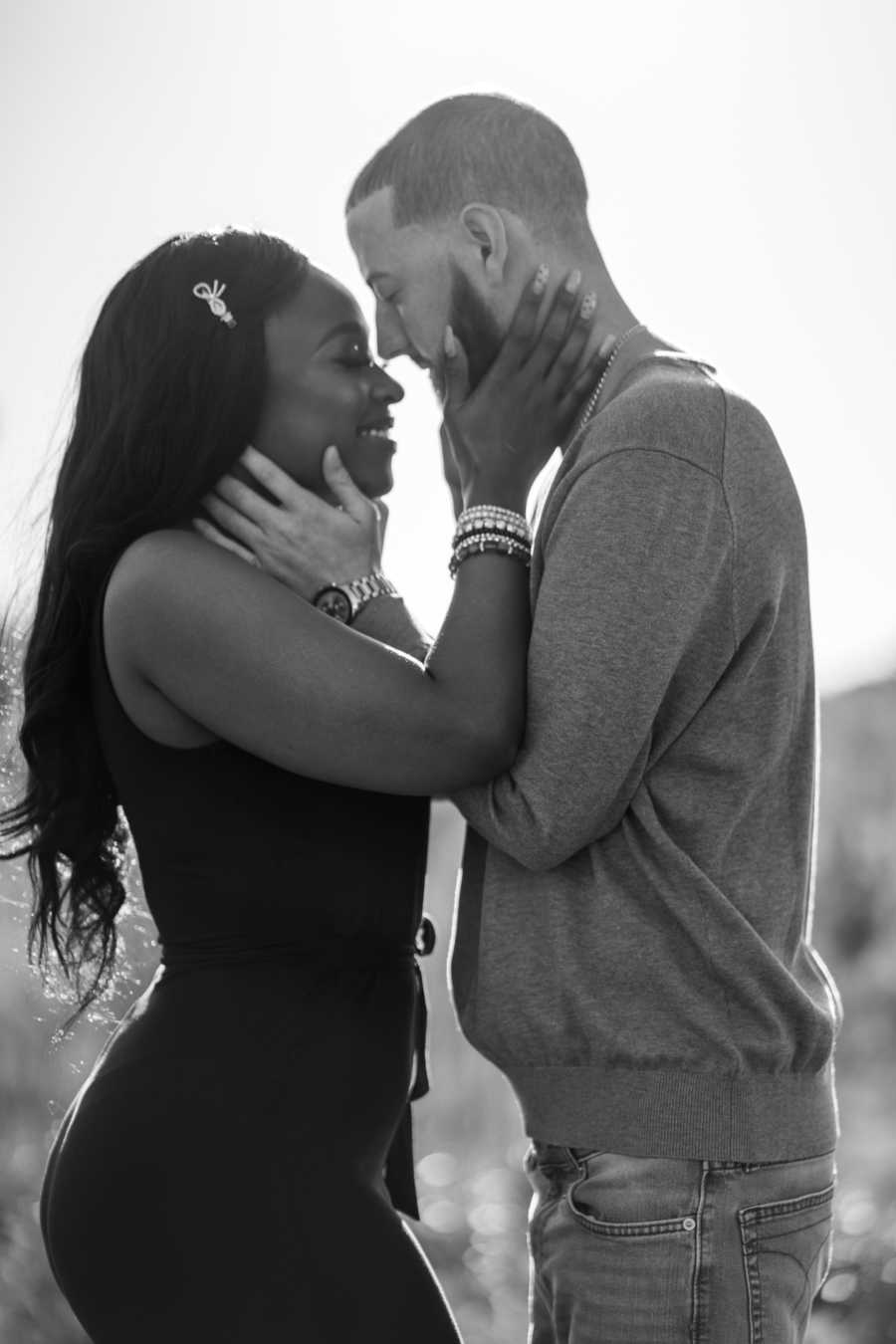 Young interracial couple share sweet, intimate moment during photoshoot