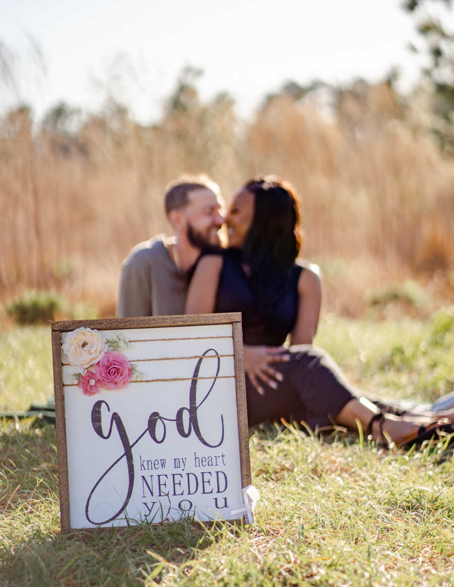 Married couple battling cancer take a photo with a sign that says "God knew my heart needed you"