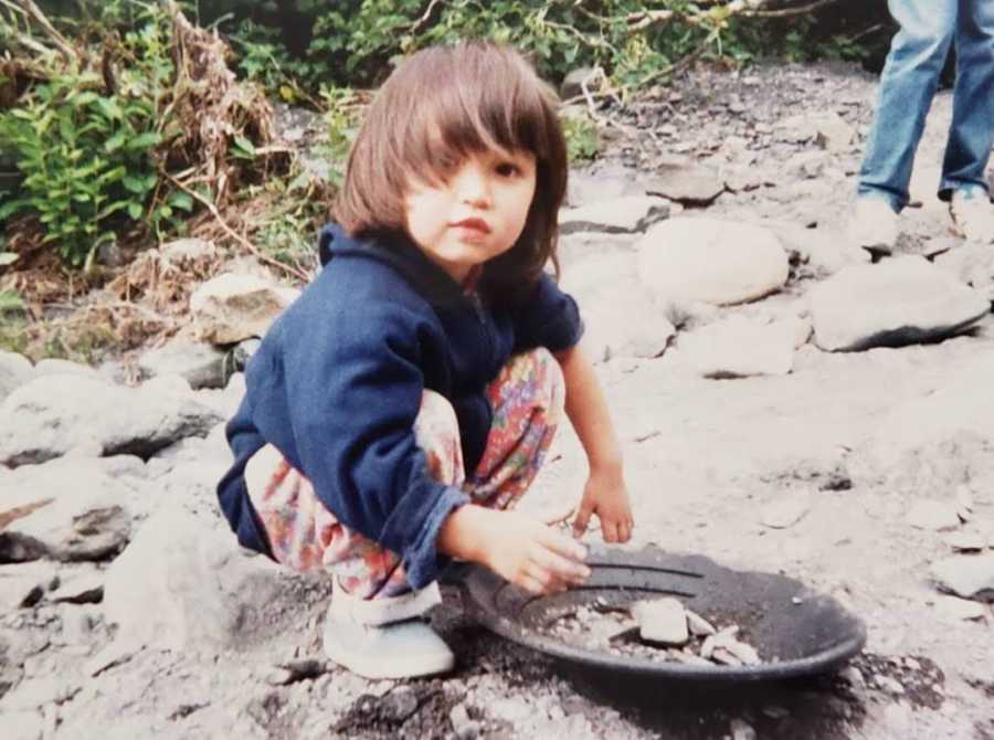 young girl playing with sand