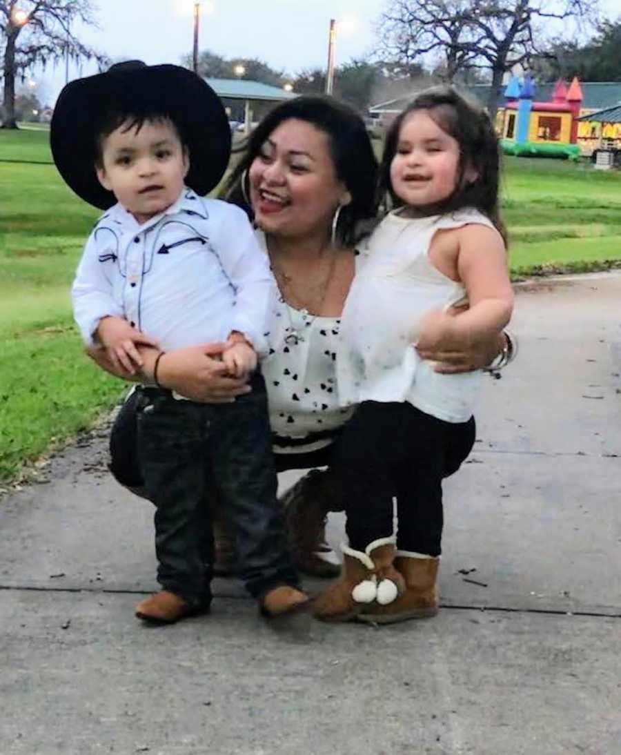 woman crouching down with her two babies