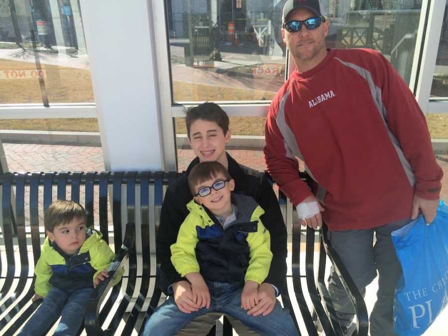 dad and 3 sons on a bench