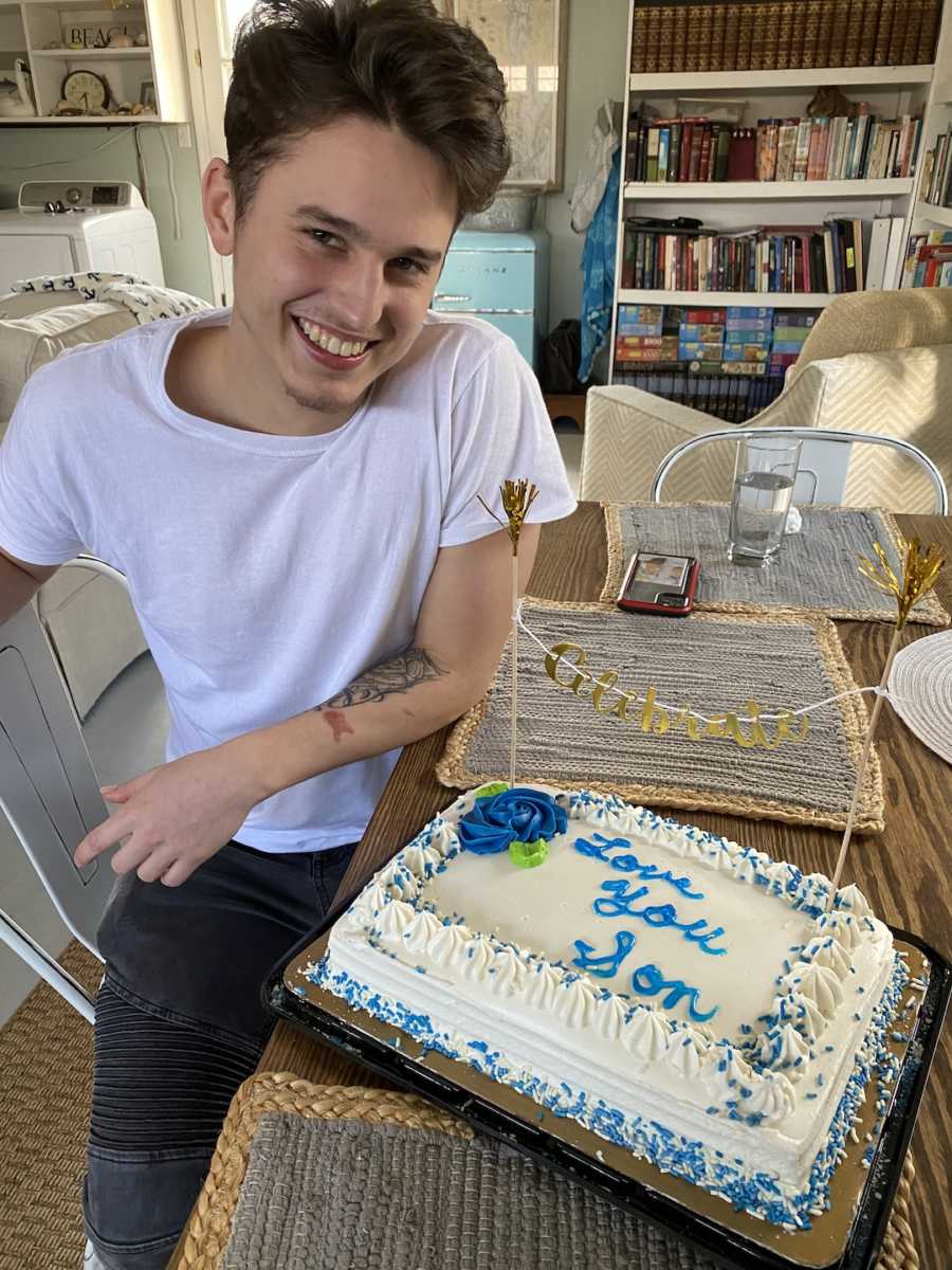 boy with cake that says "happy birthday son"