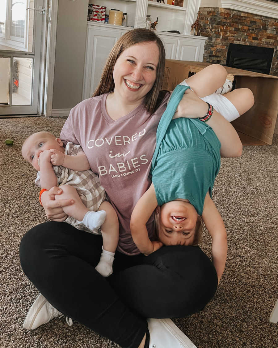 mom holding 2 kids