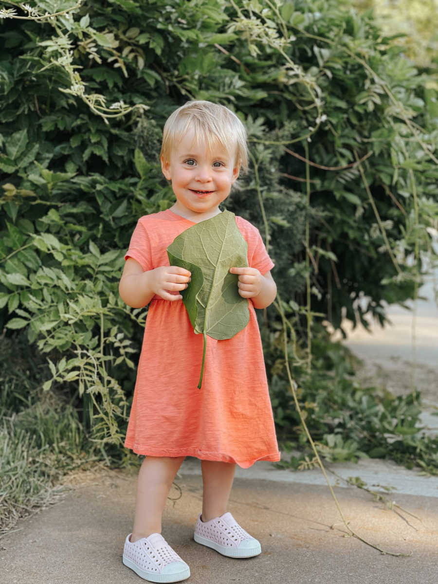 young girl holding a leaf