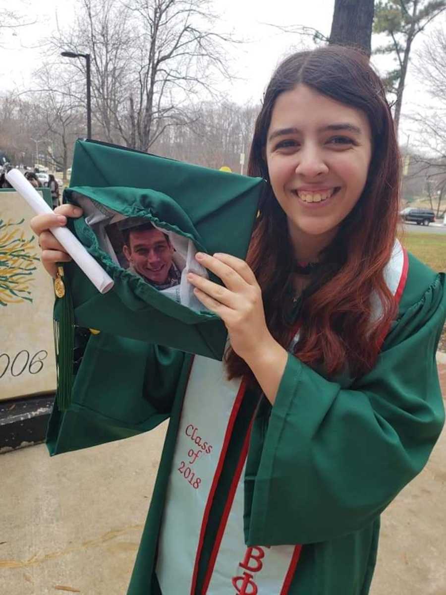 girl holding picture of dad in graduation cap