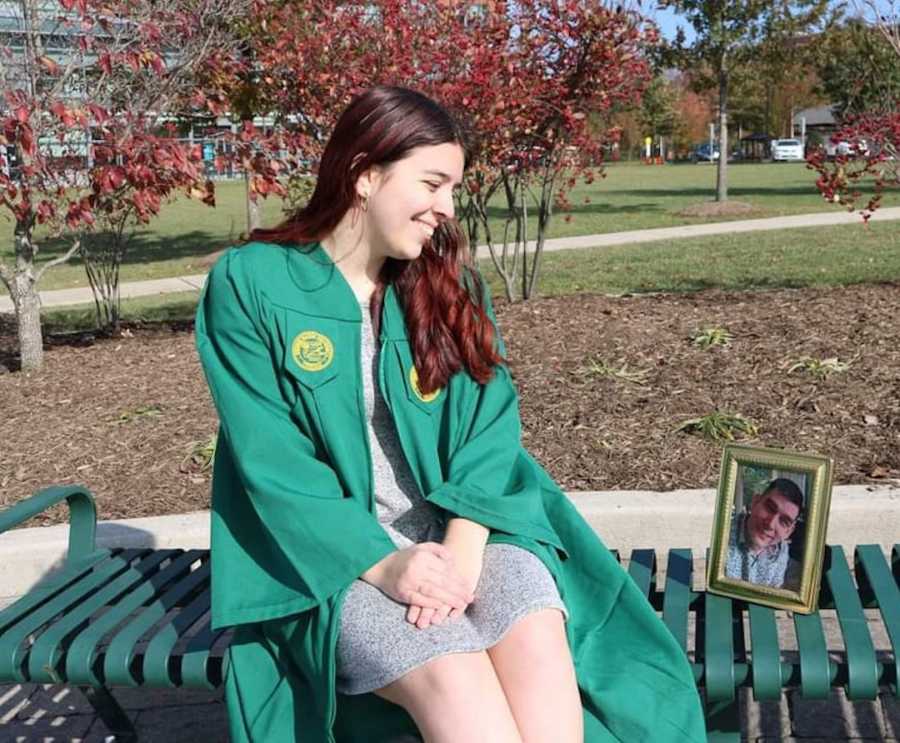 girl in cap and gown with photo of her dad