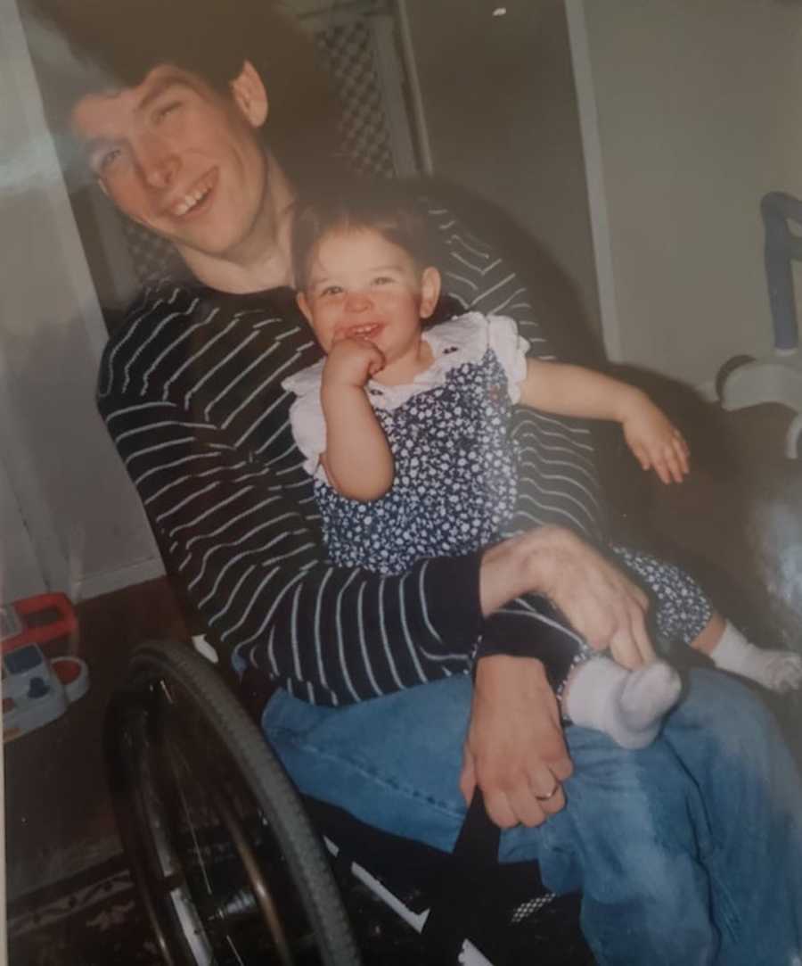 man with cerebral palsy holding daughter