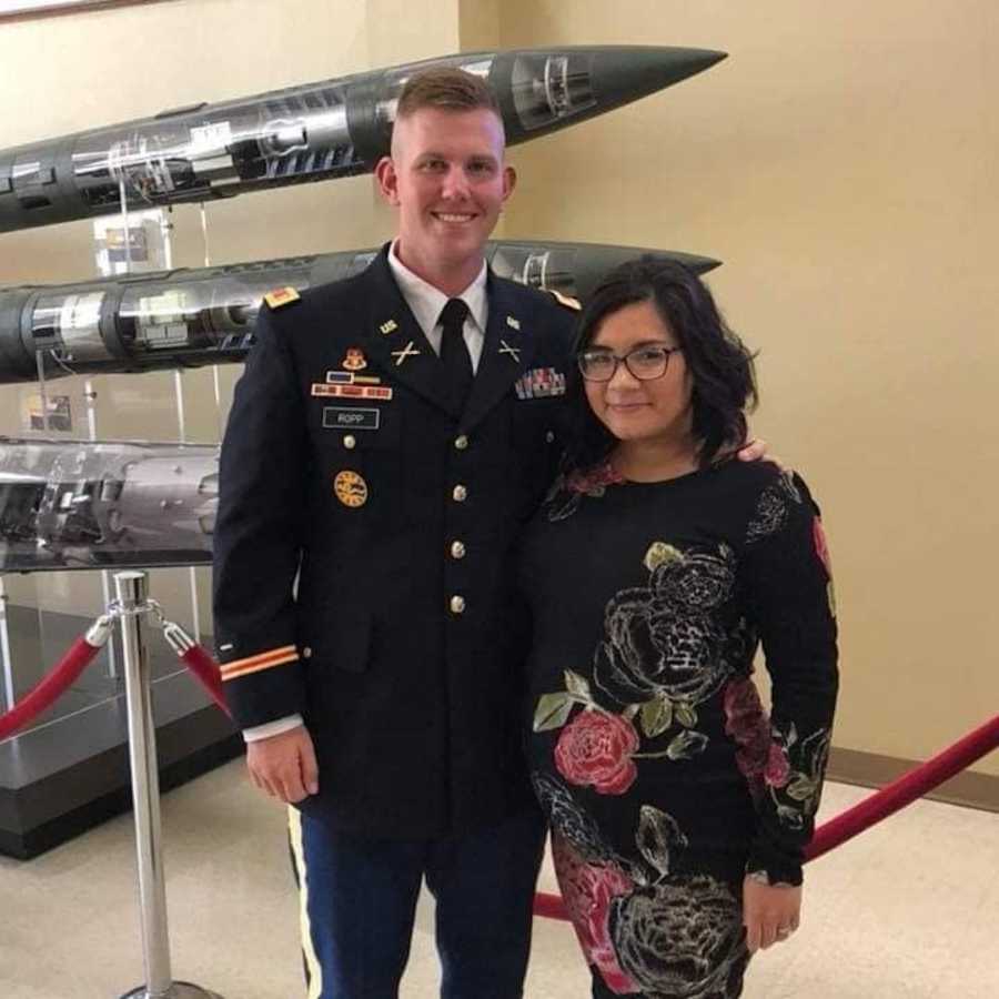 husband and wife standing in a museum