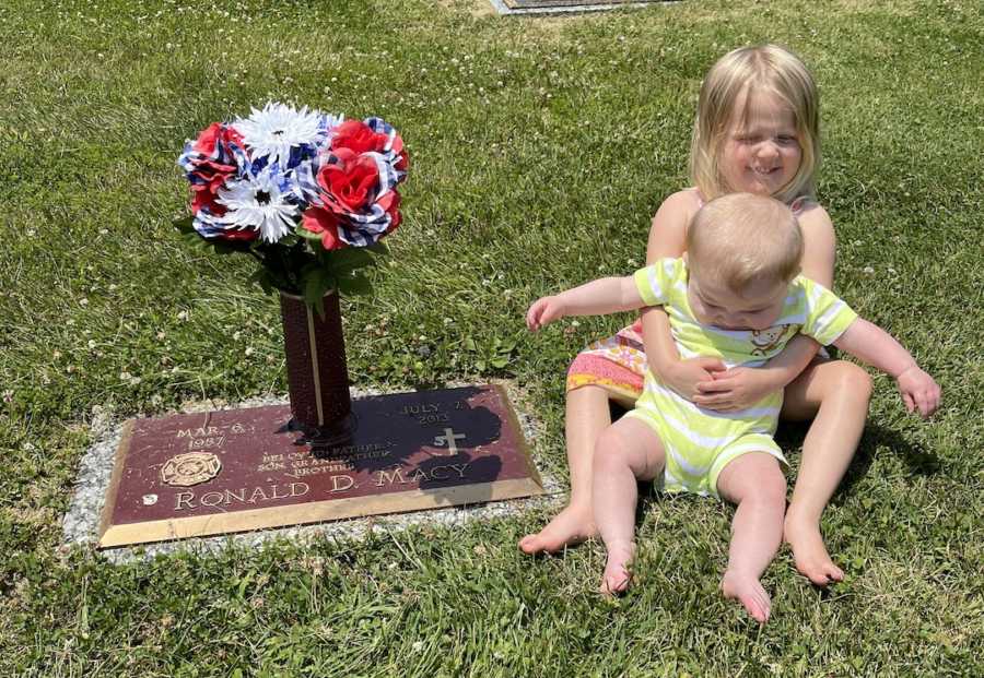 photo of two kids by grandpa's grave