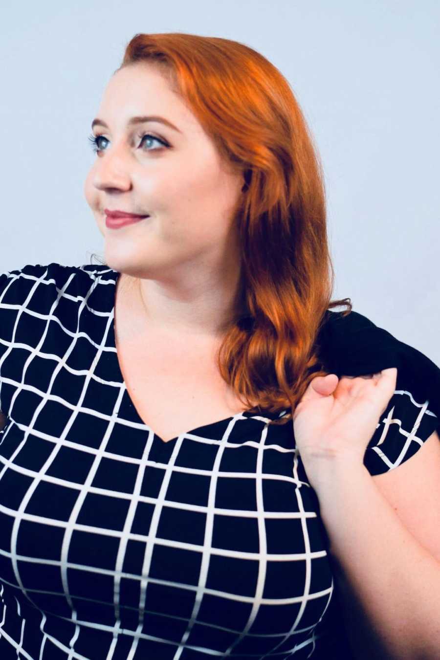 woman smiling in checkered shirt