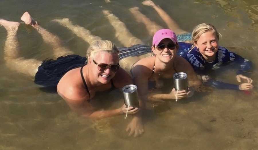 woman holding drinks in the water