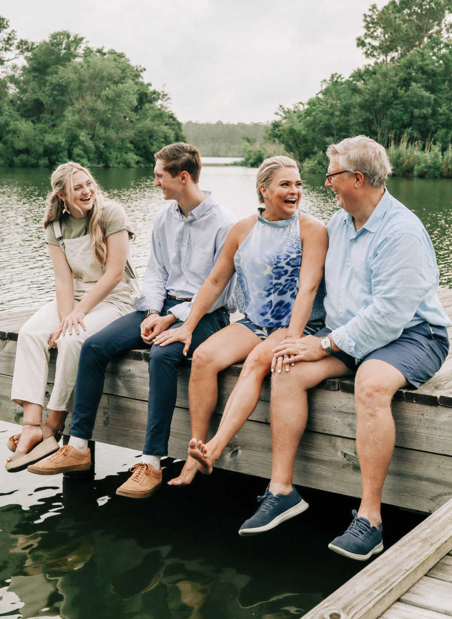 group of people sitting on the dock