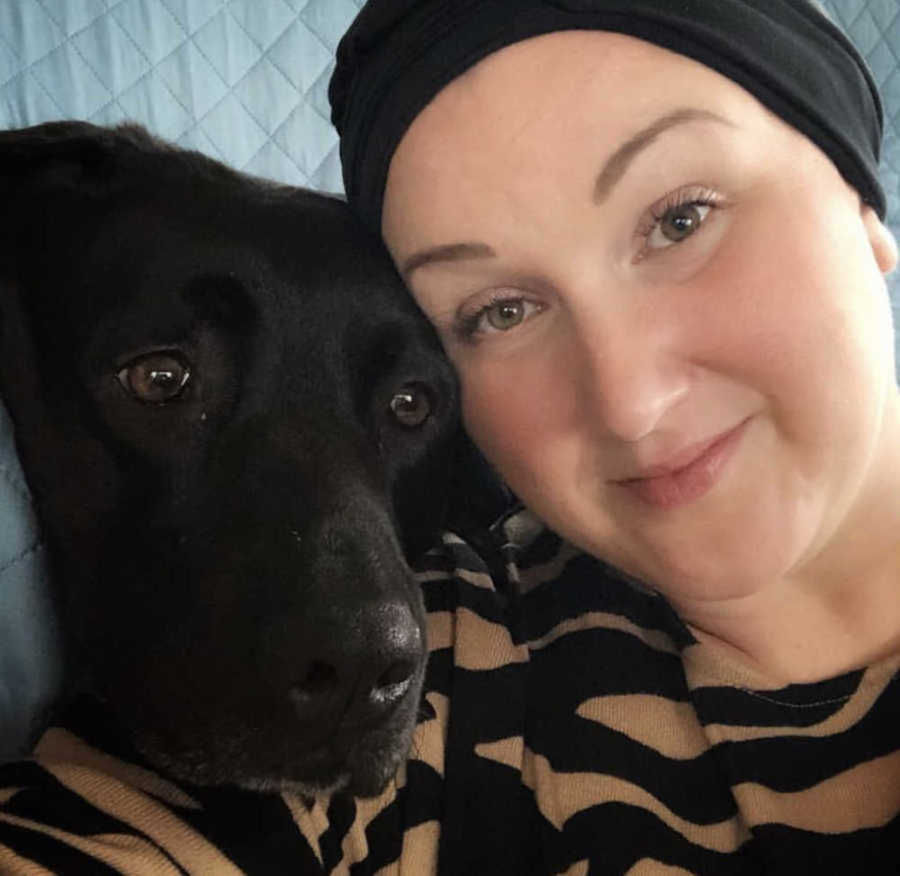 woman with head covering and dog