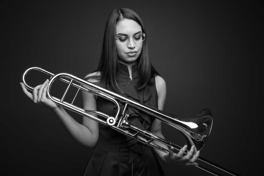 woman holding a trombone