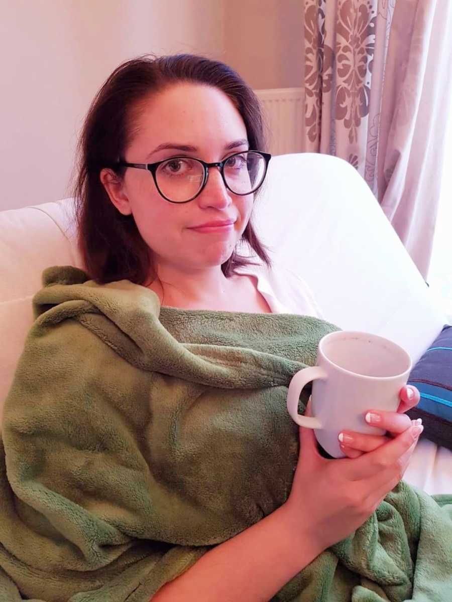 woman holding a mug in bed
