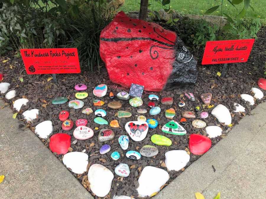 painted rocks in a garden