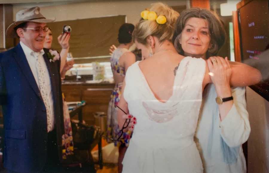 woman with parents at her wedding