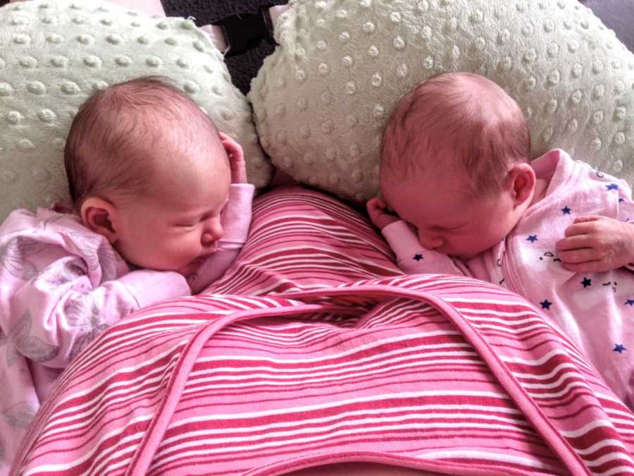 Mom of three snaps photo of twin daughters as they sleep after feeding