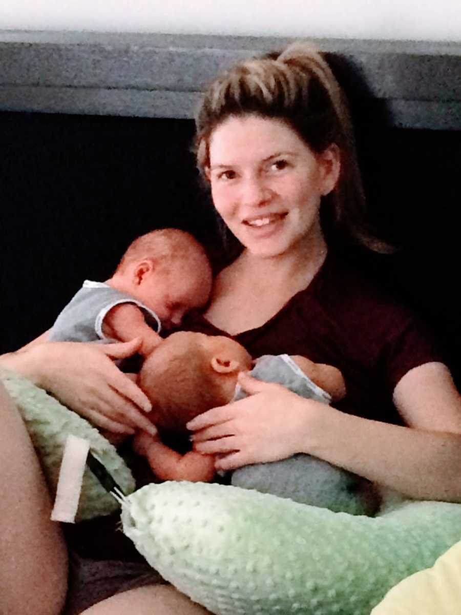 Mom of three holds her newborn twins while they sleep on her chest